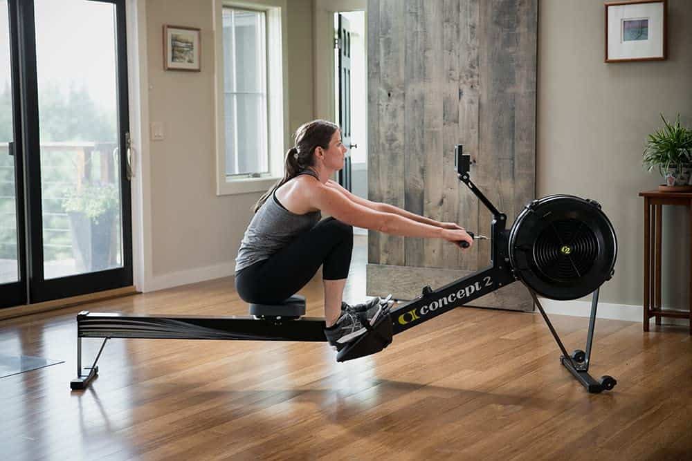 A lady is working out on the Concept2 Model D Indoor Rowing Machine