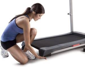 A user adjusts the incline of the Weslo Cadence G 5.9 Treadmill