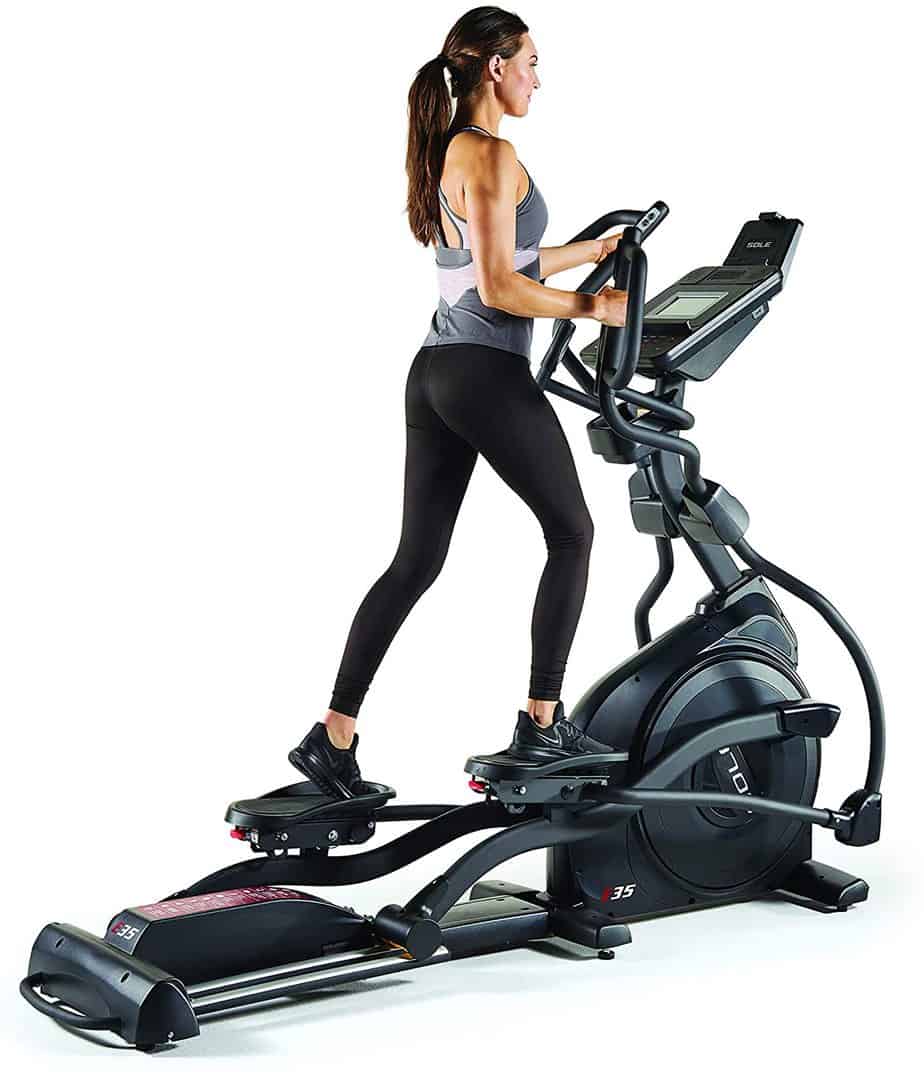 A lady is exercising on the Sole E35 Elliptical Trainer