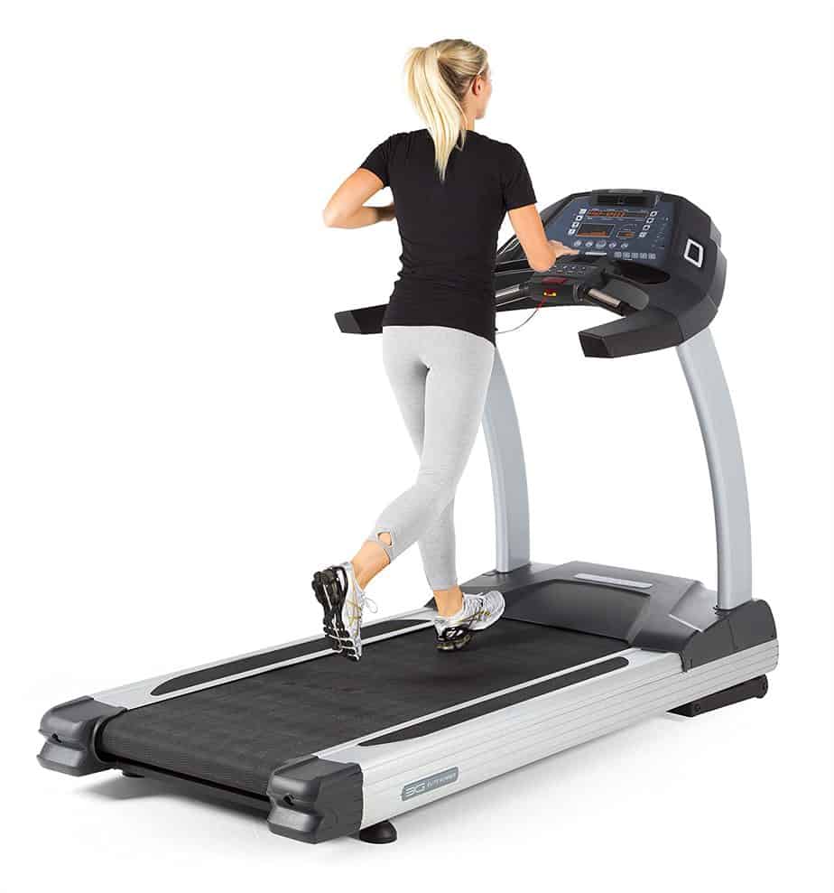 A lady is running on the 3G Cardio Elite Runner Treadmill