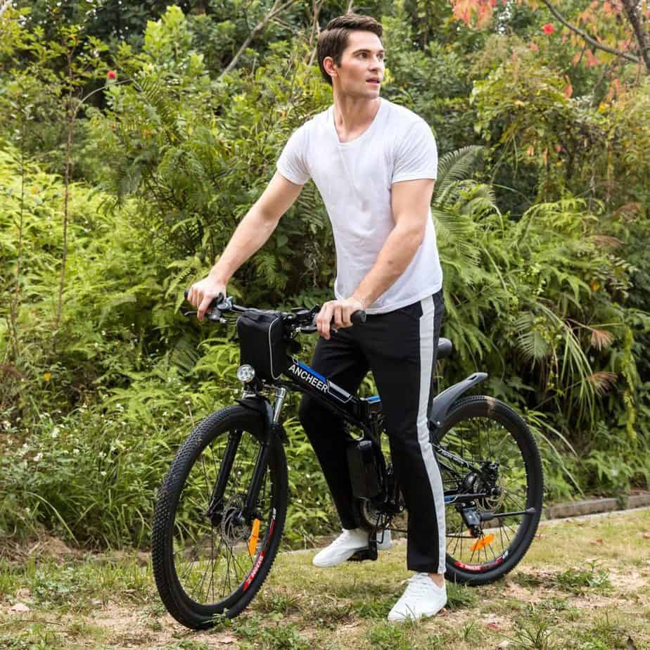 A man is on top of the Ancheer Power Plus Folding Electric Mountain Bike With 26’’ Wheel