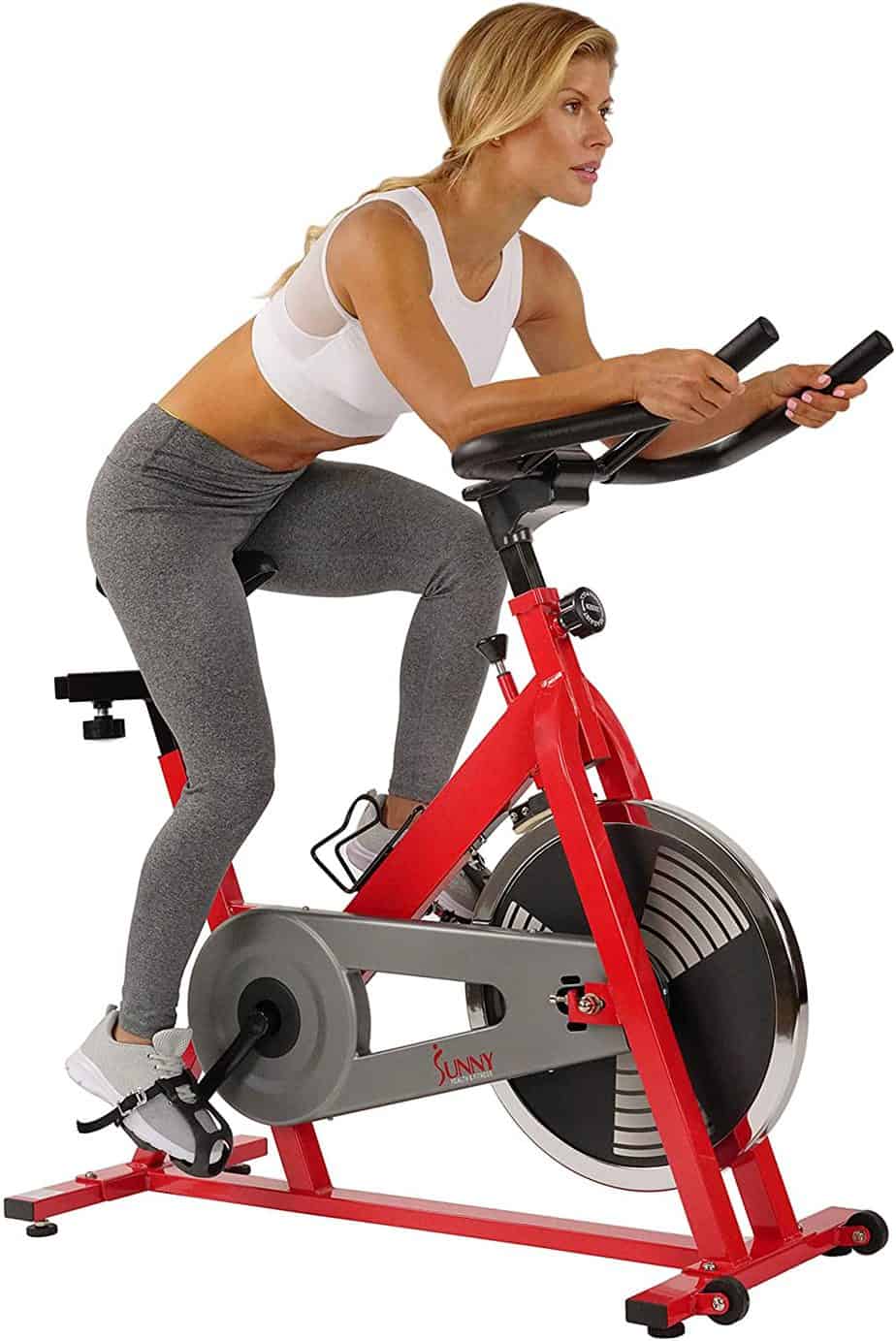 A lady is exercising with the Sunny Health and Fitness SF-B1001 Indoor Cycling Bike