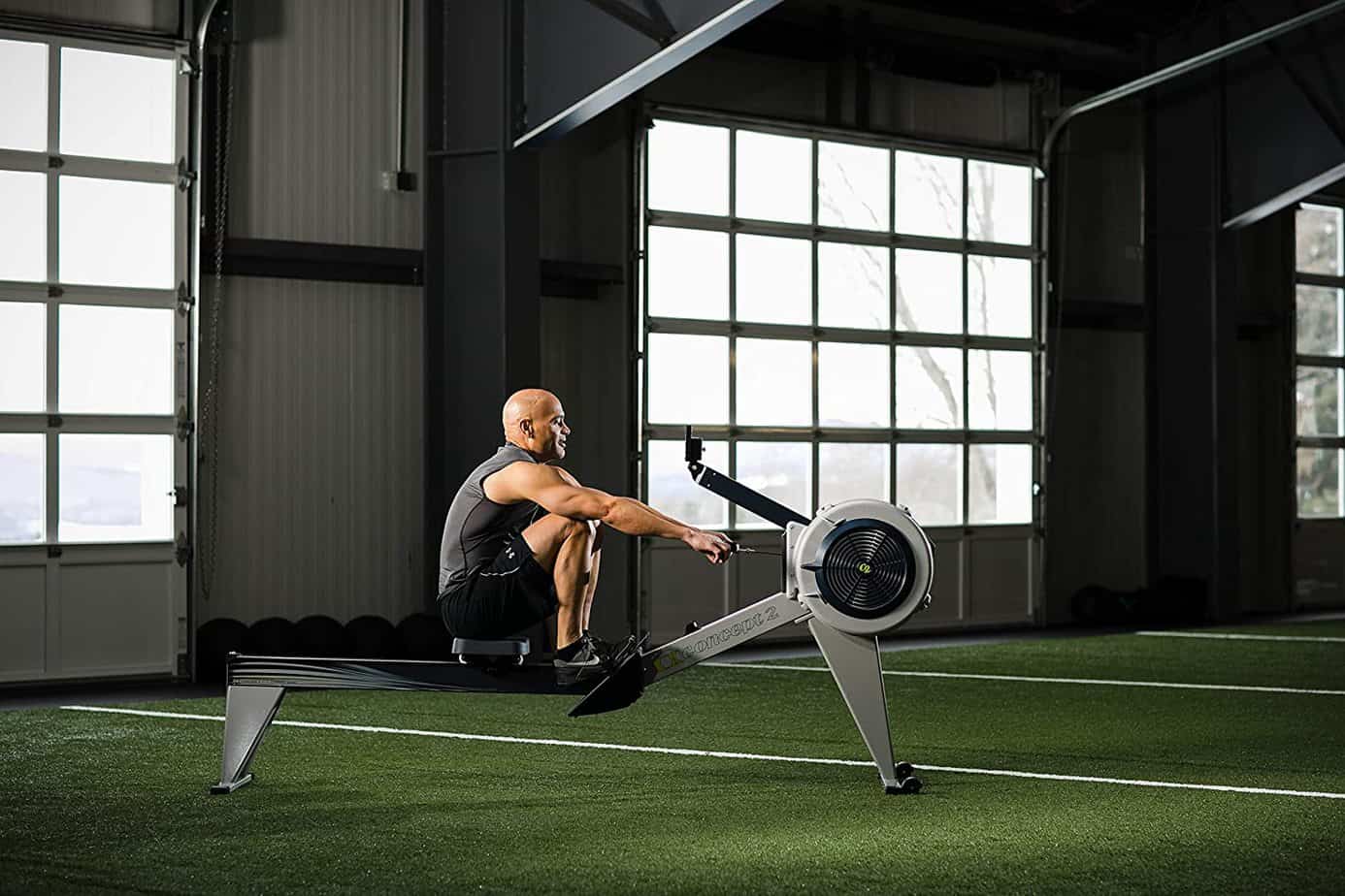 A man is rowing on the Concept2 Model E Indoor Rowing Machine