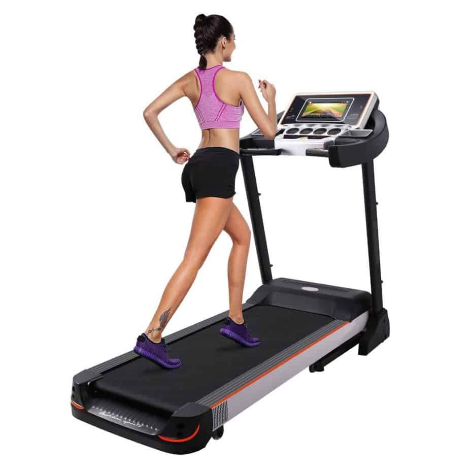 A lady exercising on the Bellar 10.1 Inch WIFI Large Color Touch Screen 3.0 HP Folding Electric Treadmill