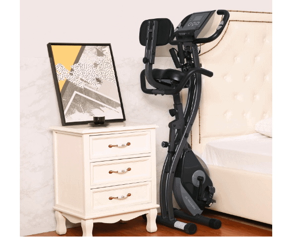 MaxKare Magnetic Folding Semi-Recumbent Bike stored at a bed side