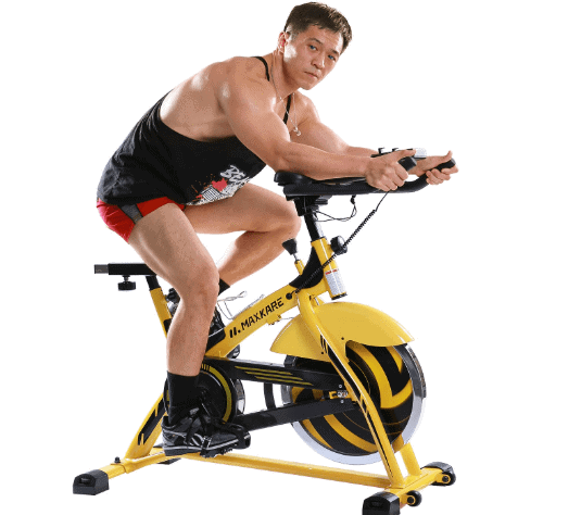 MaxKare Stationary Cycling Spin Bike is being ridden by a man