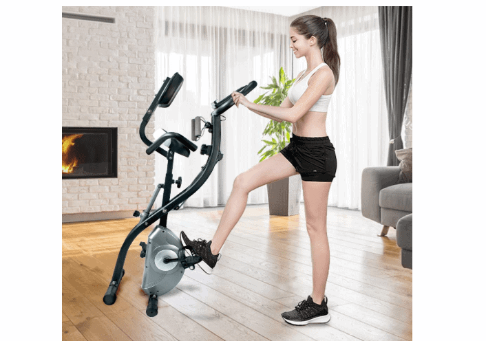 A lady rolling the ATIVAFIT Stationary Foldable Exercise Bike away for storage