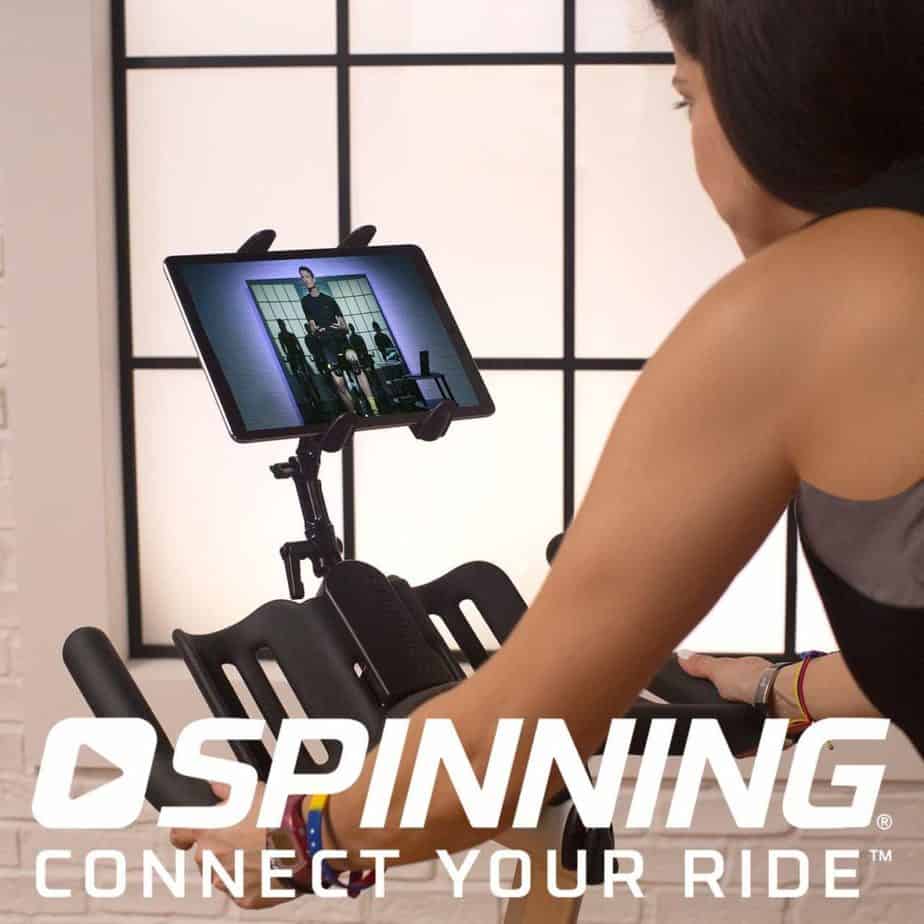 Spinner P3 Indoor Cycling Bike is being ridden by a lady that is also streaming spin bike training