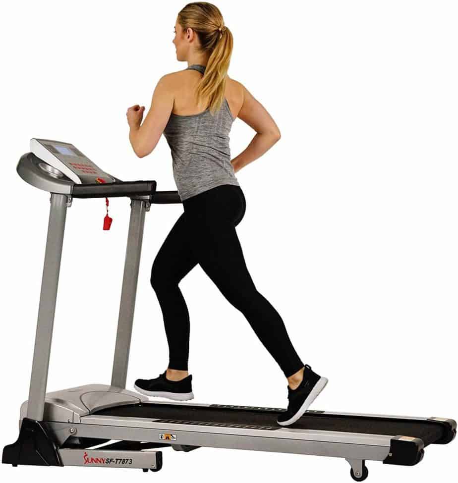 An athlete is running on the Sunny Health & Fitness Electric Folding Treadmill SF-T7873