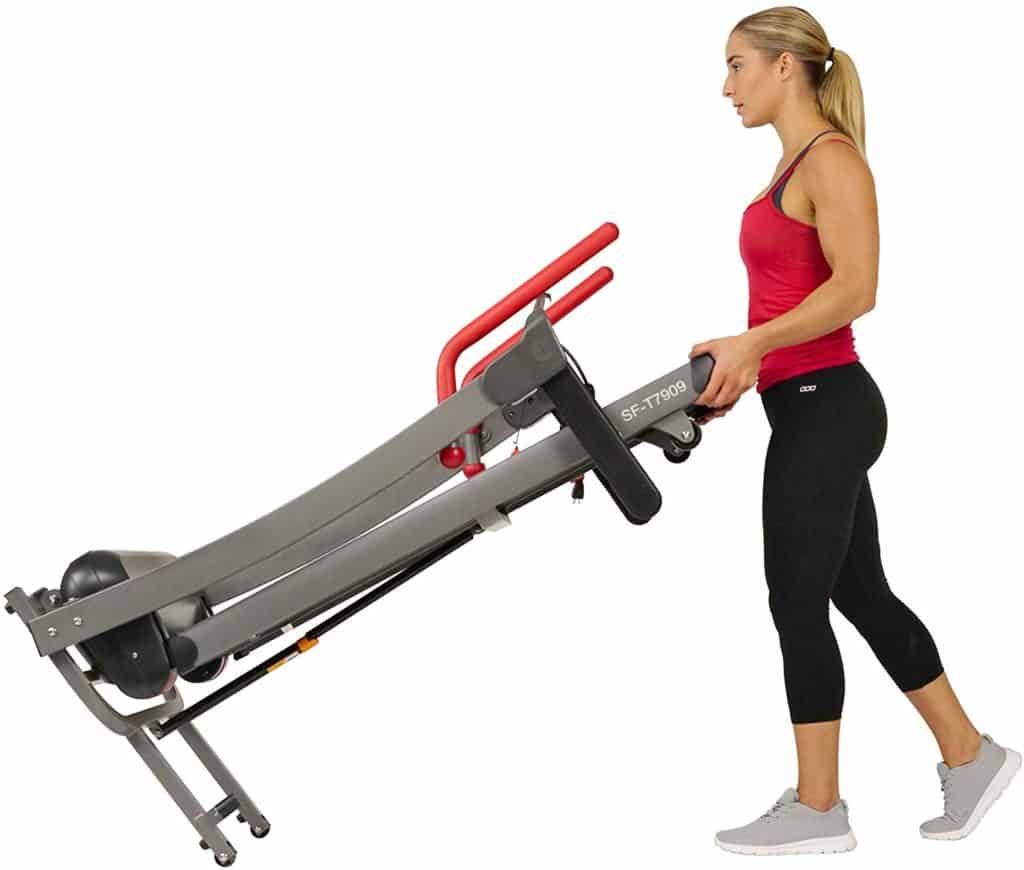 The Sunny Health & Fitness Folding Electric Treadmill SF-T7909 is being moved to storage