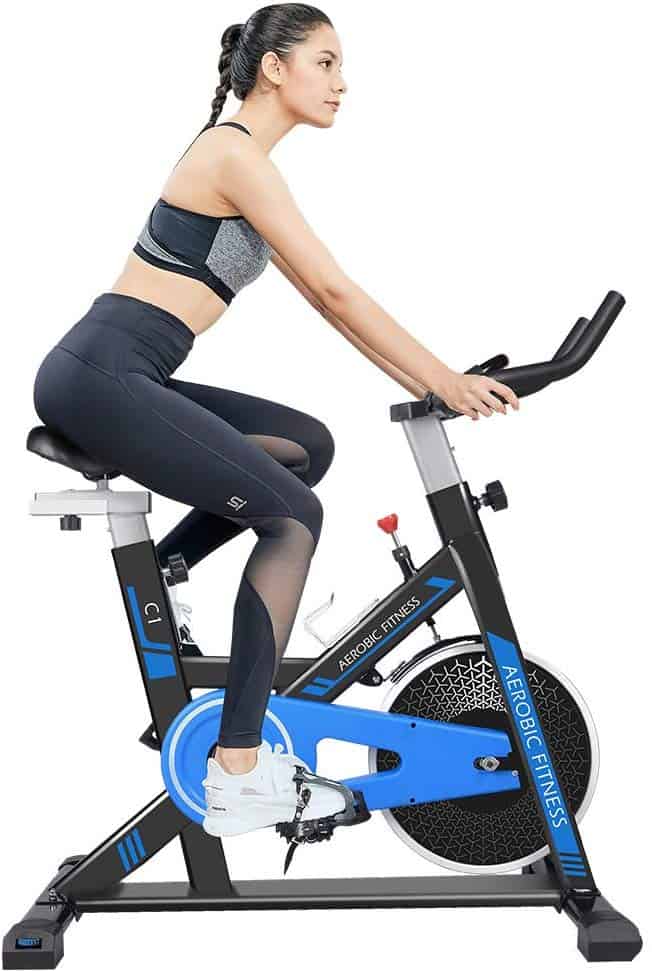 A lady is exercising with the Cycool Belt Drive Stationary Bike (C1)