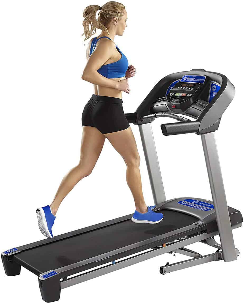 A lady is exercising on theHorizon T101 Treadmill (2018)