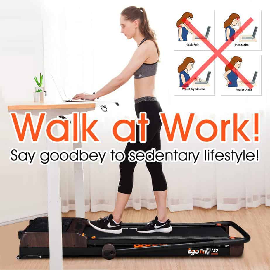 A lady walks and works on the Egofit M2 Treadmill