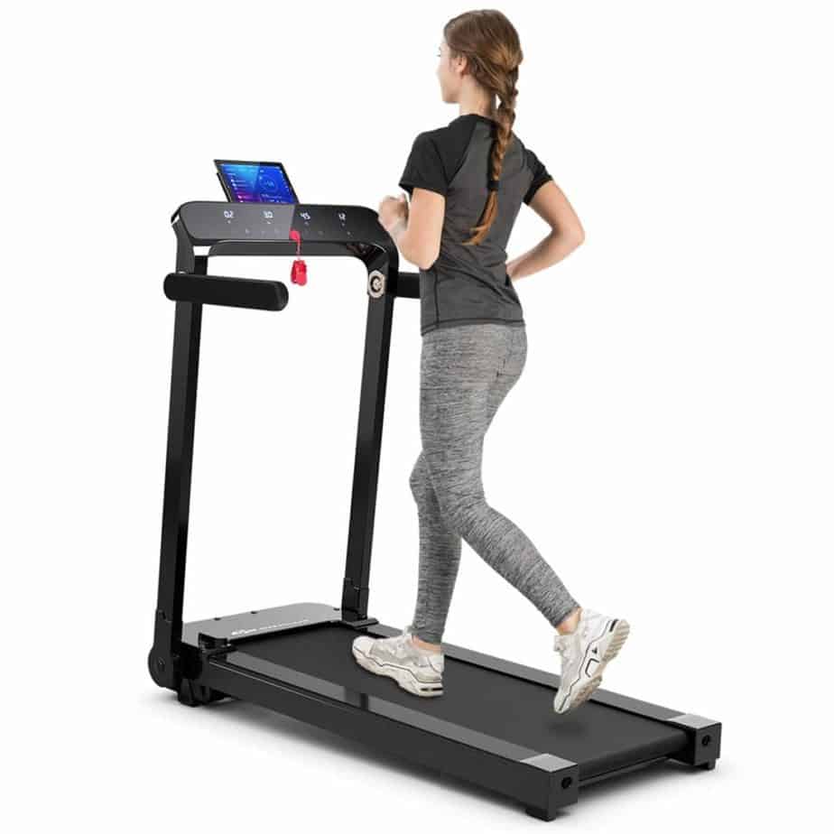 A lady is jogging on the Goplus Electric Folding Treadmill 