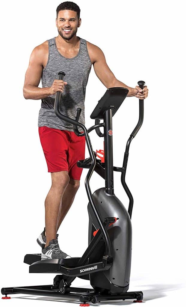 A man is exercising with the Schwinn 411 Compact Elliptical