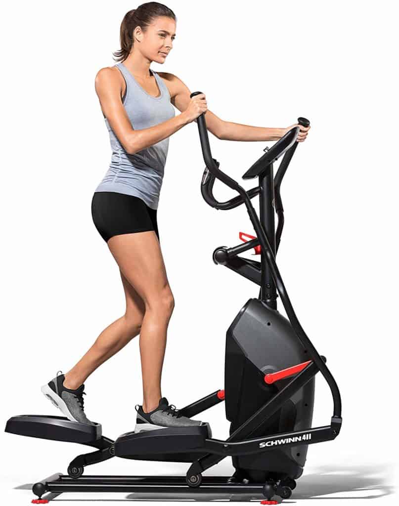 A lady is working out with the Schwinn 411 Compact Elliptical