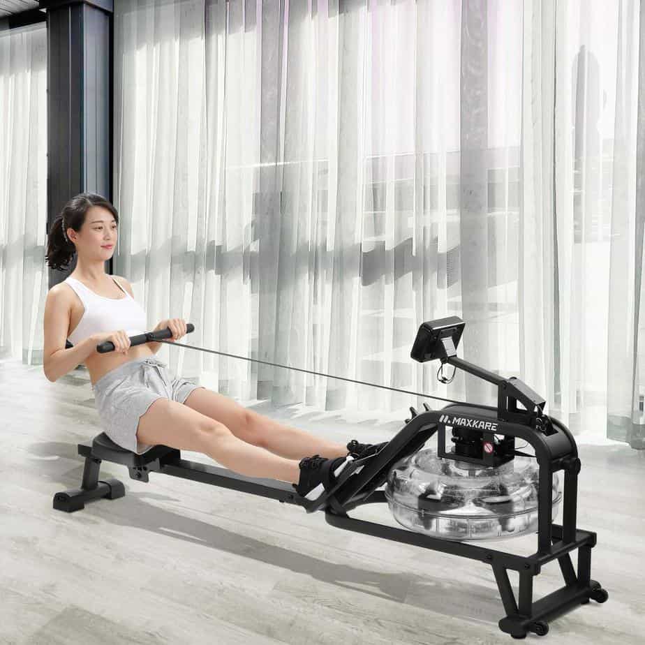 A lady rowing on the Maxkare Water Rowing Machine