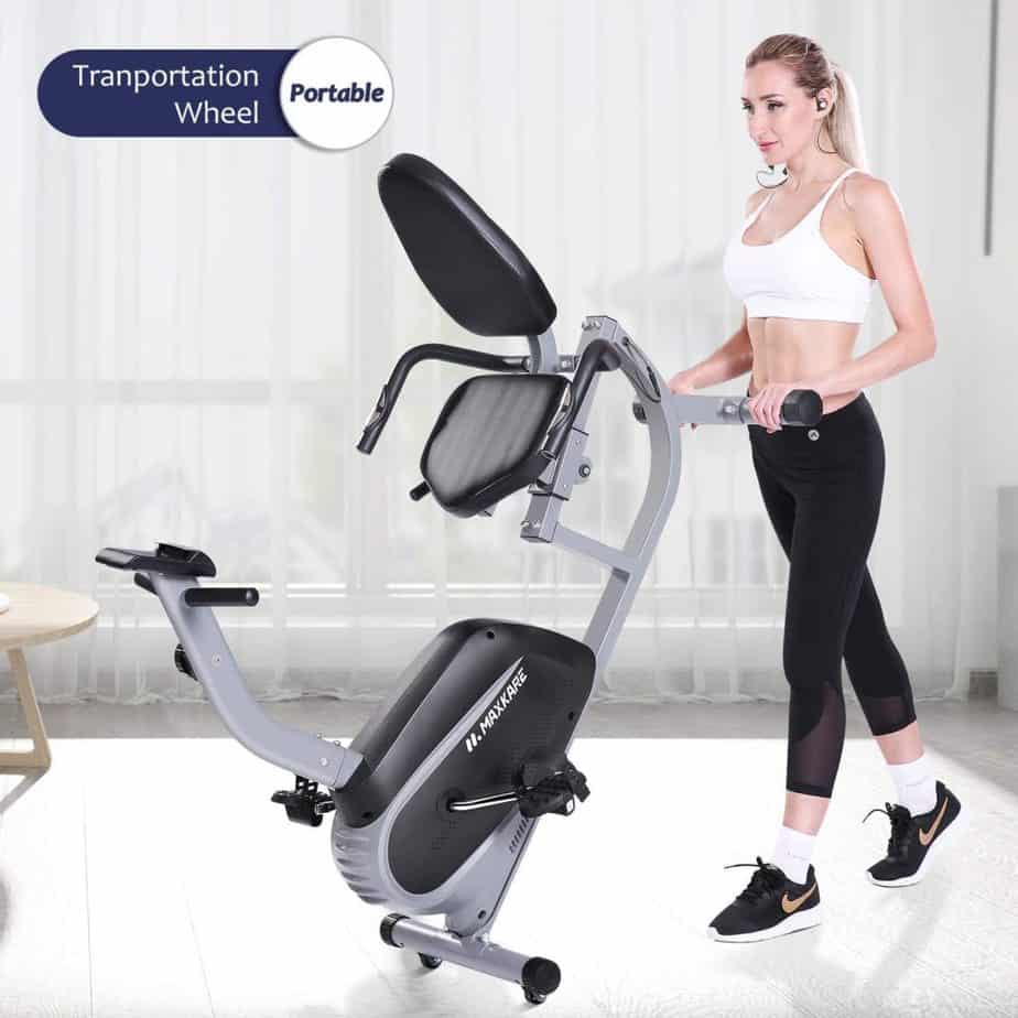 The MaxKare Recumbent Exercise Bike being rolled to storage by a lady