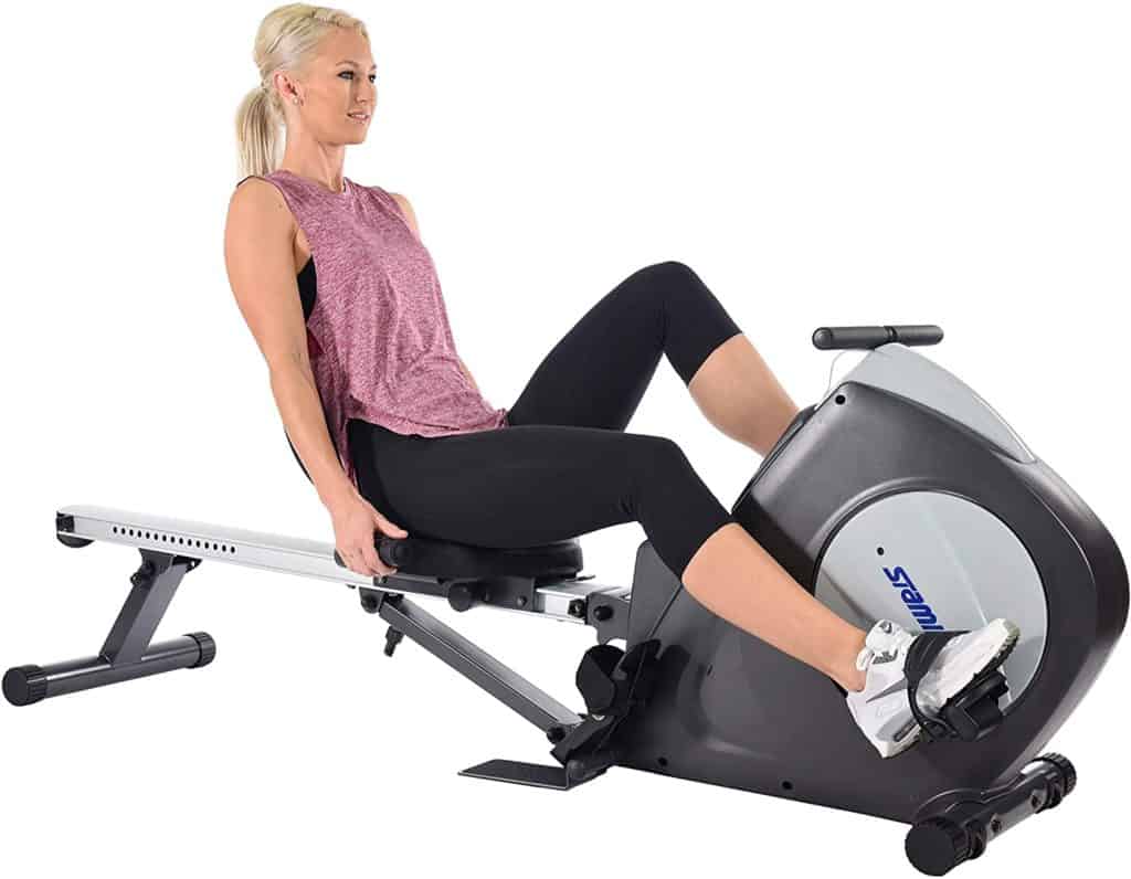 A woman is biking on the Stamina Conversion II Recumbent Bike/Rower 