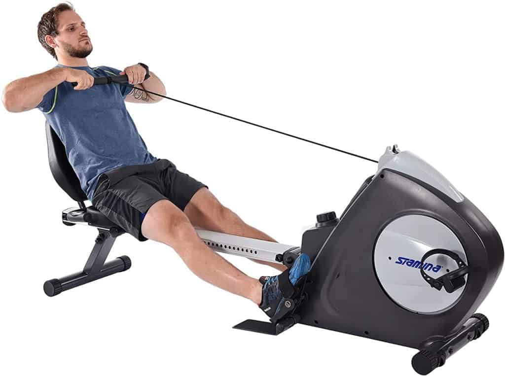 A man is rowing on the Stamina Conversion II Recumbent Bike/Rower 