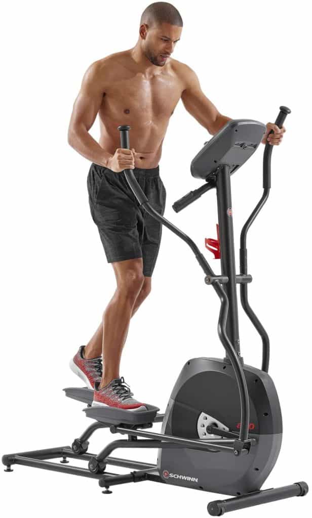 A man is working out with Schwinn A40 Compact Elliptical 100330 