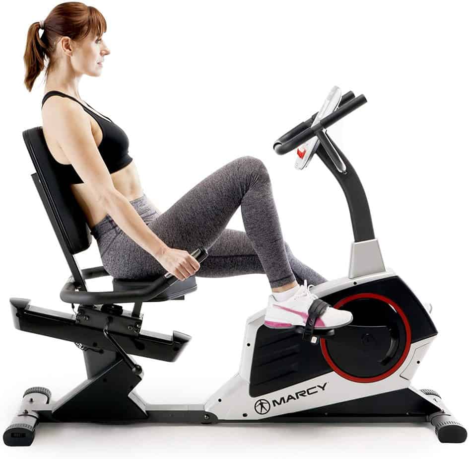 A lady is riding the Marcy Regenerating ME-706 Recumbent Bike