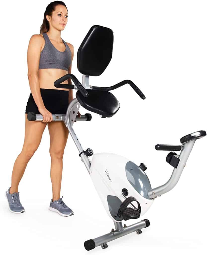 The lady rolls the Velocity Exercise CHB-R2102 Recumbent Bike away for storage