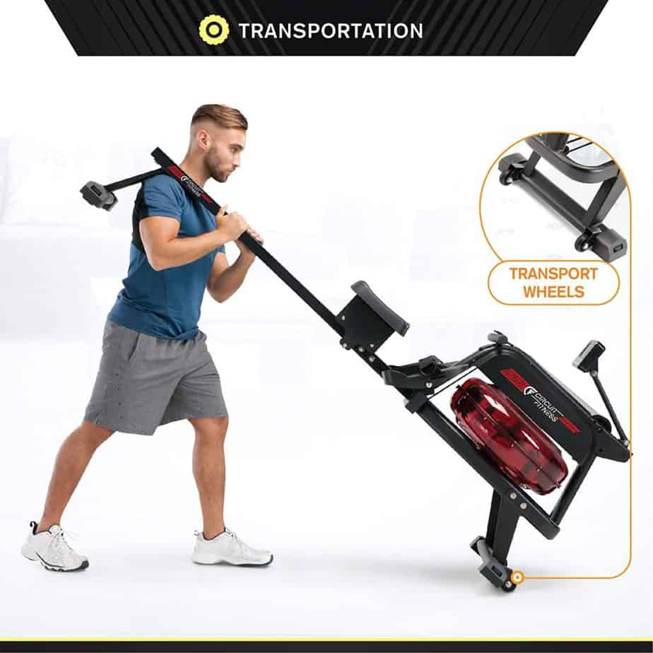 A man moving the Circuit Fitness AMZ-167RW Water Rowing Machine for storage