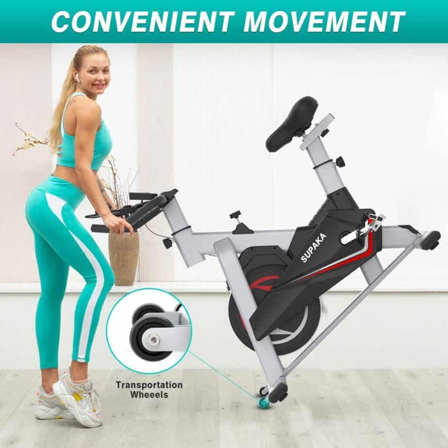 A lady moves the SUPAKA Indoor Magnetic Spin Bike for storage