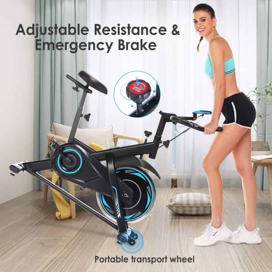 A lady moves the FUNMILY Indoor Stationary Exercise Bike for storage