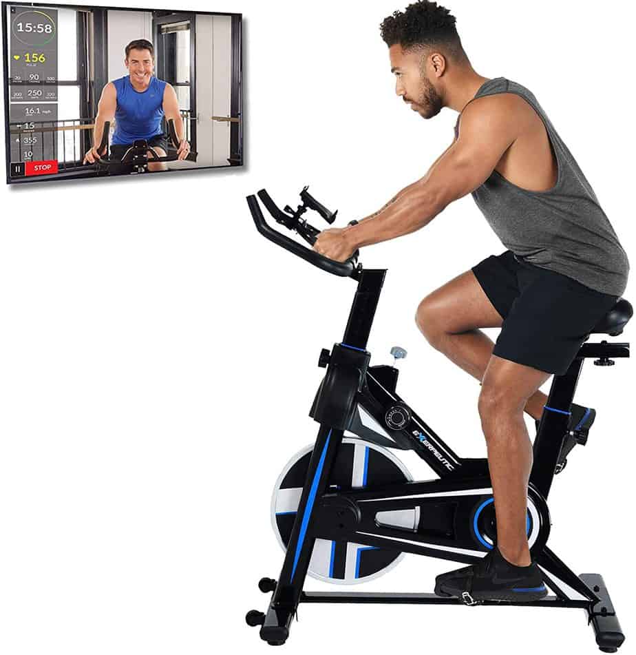 A trainer exercises with the Exerpeutic LX 3000 Indoor Cycling Exercise Bike (4210)