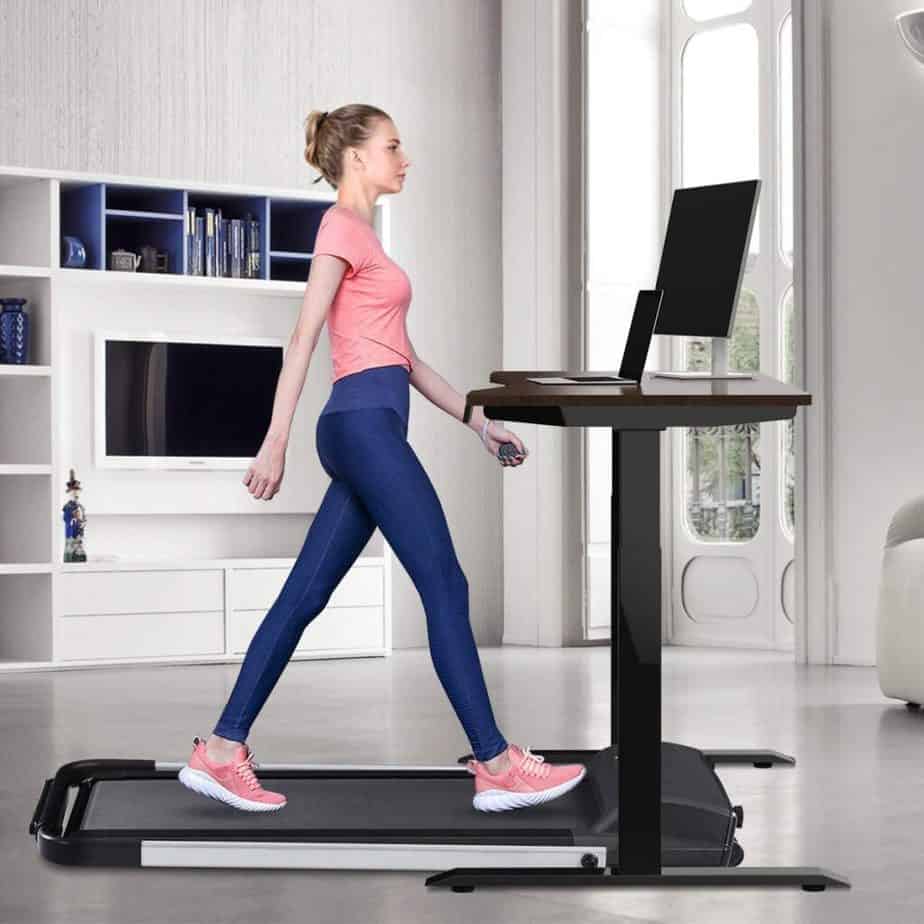 A lady uses the Estleys 2-in-1 Under-Desk Treadmill under a desk