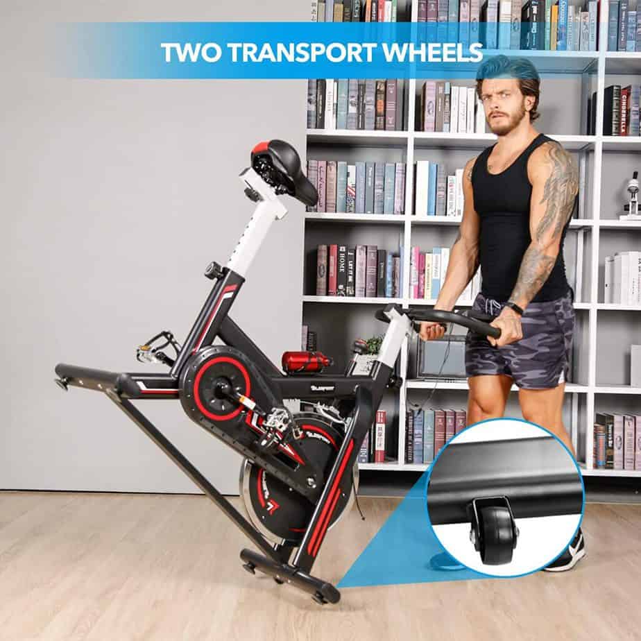 A user rolls the TELESPORT Indoor Cycling Bike away for storage