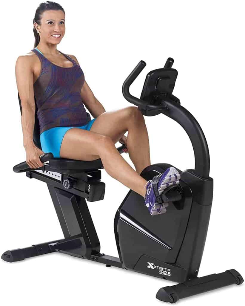 A lady exercises with the XTERRA SB2.5R Exercise Recumbent Bike