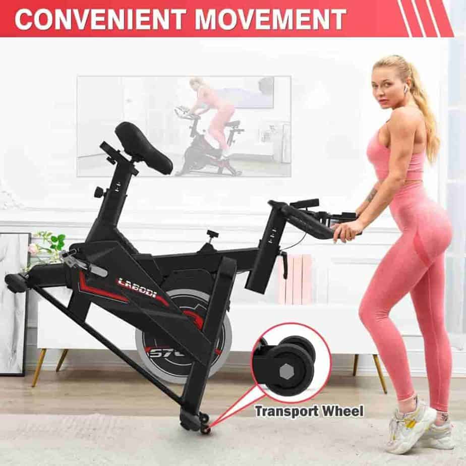 A lady rolls the LABODI Exercise Bike away for storage