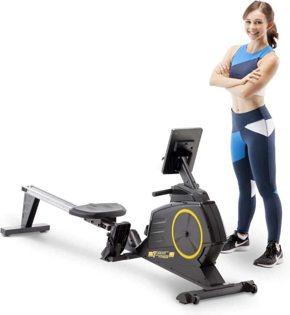 A lady stands beside the Circuit Fitness AMZ-986RW-BT Magnetic Rowing Machine