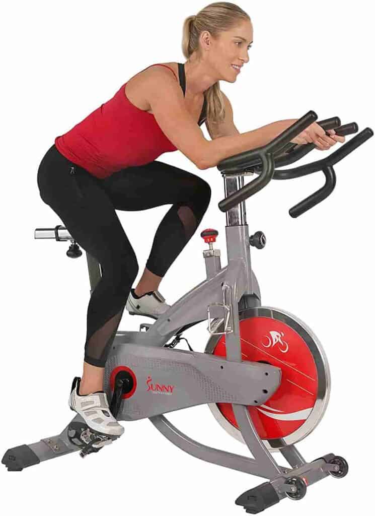 A lady rides the Sunny Health & Fitness SF-B1711 AeroPro Indoor Cycling Bike