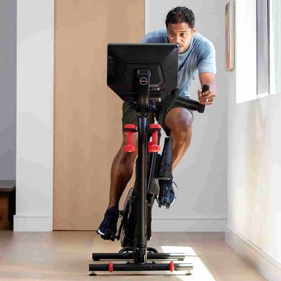 A user uses the leaning mode of Bowflex VeloCore 16 IC Bike 