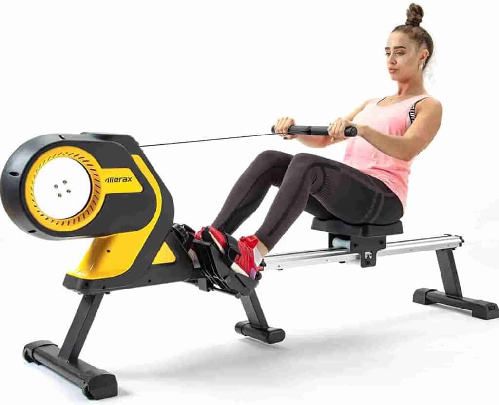 A lady rows on the Merax Folding Magnetic Rowing Machine 