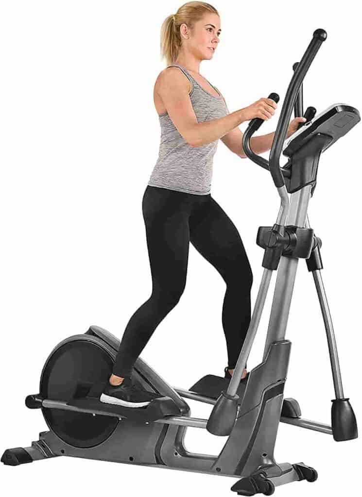 A lady exercises with the Sunny SF-E3912 Magnetic Elliptical Trainer