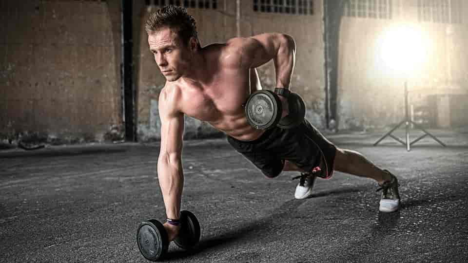 A man exercises with dumbbells