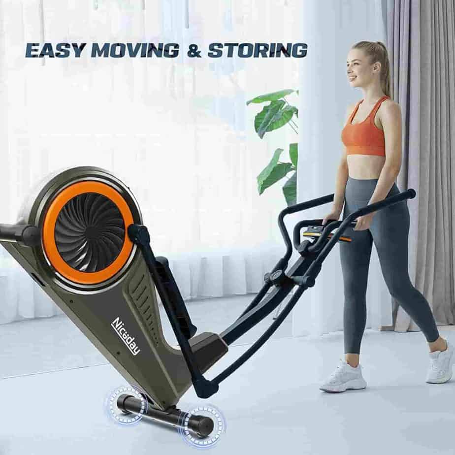 A lady moves the Niceday CT11 Elliptical Trainer for storage 