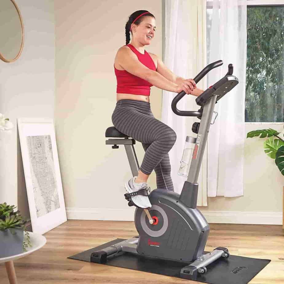 A lady rides the Sunny Health & Fitness SF-B220045 Upright Bike
