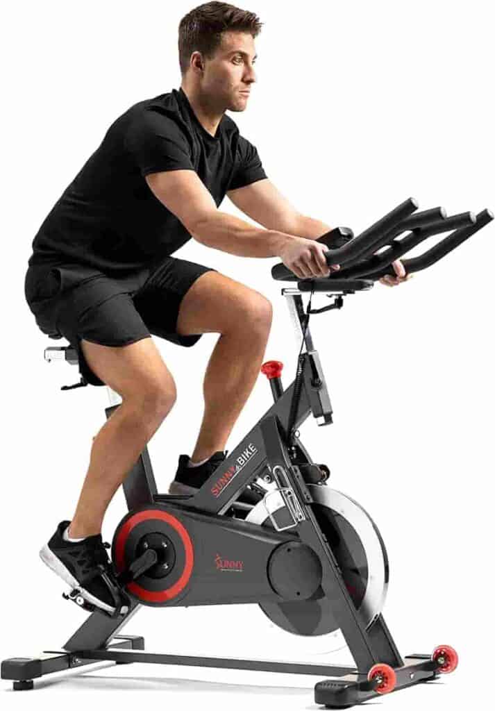 Man exercises with the Sunny Health & Fitness SF-B1805SMART Exercise Bike 