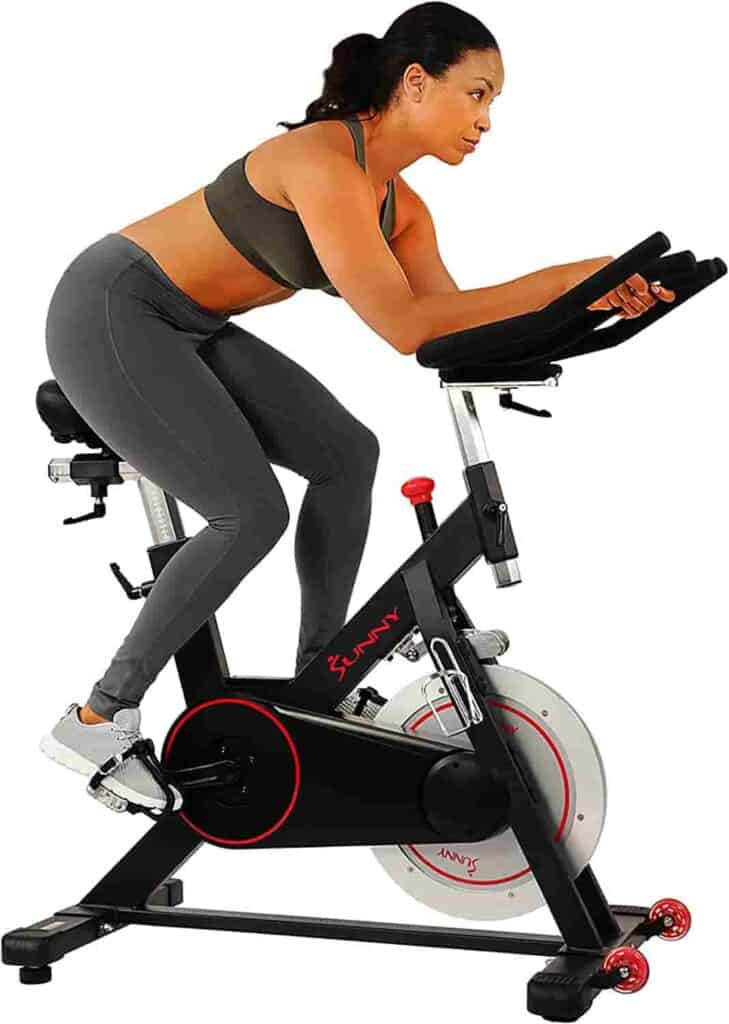 A lady exercises with the Sunny Health & Fitness SF-B1805 Exercise Bike