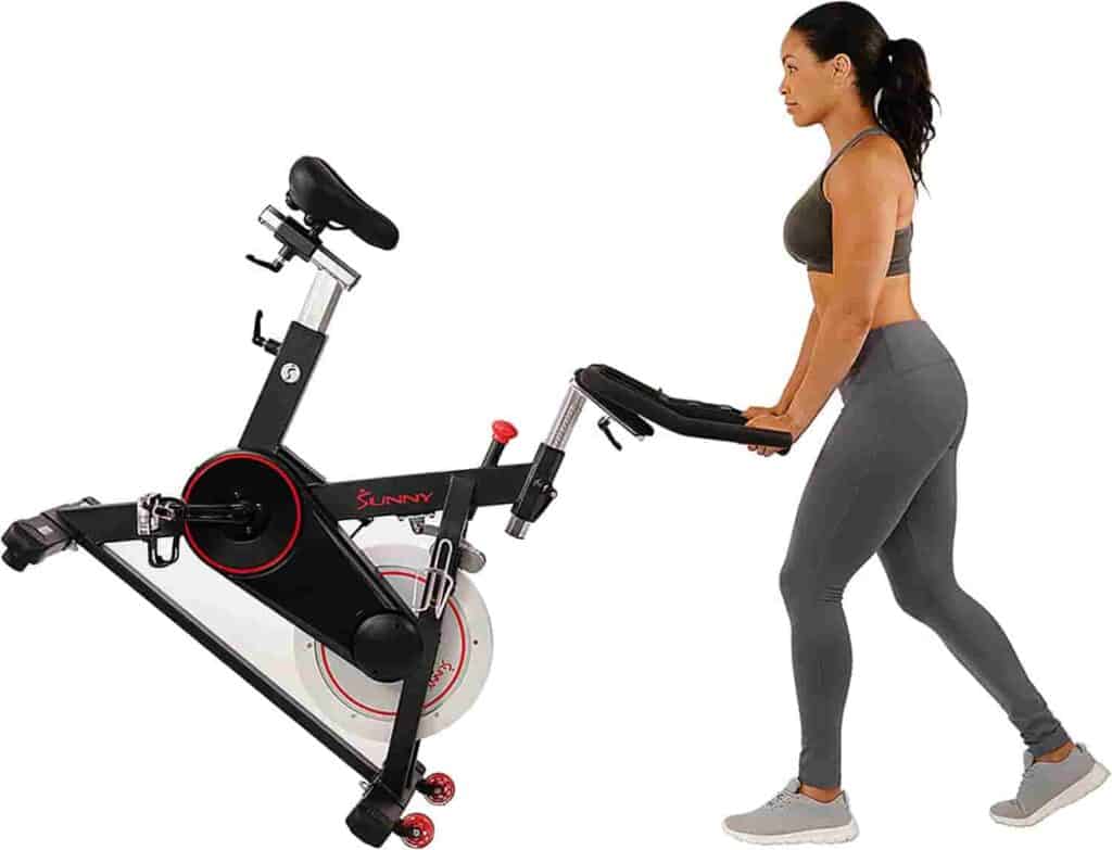 This user moves the Sunny Health & Fitness SF-B1805 Exercise Bike to storage 