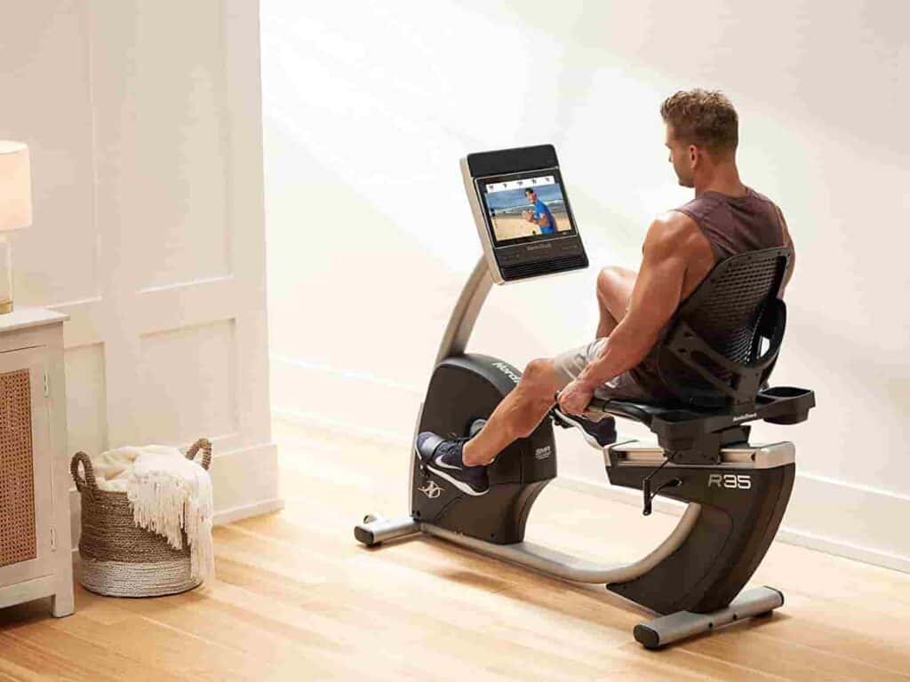 A man exercises with the Nordic Track R35 Commercial Recumbent Bike