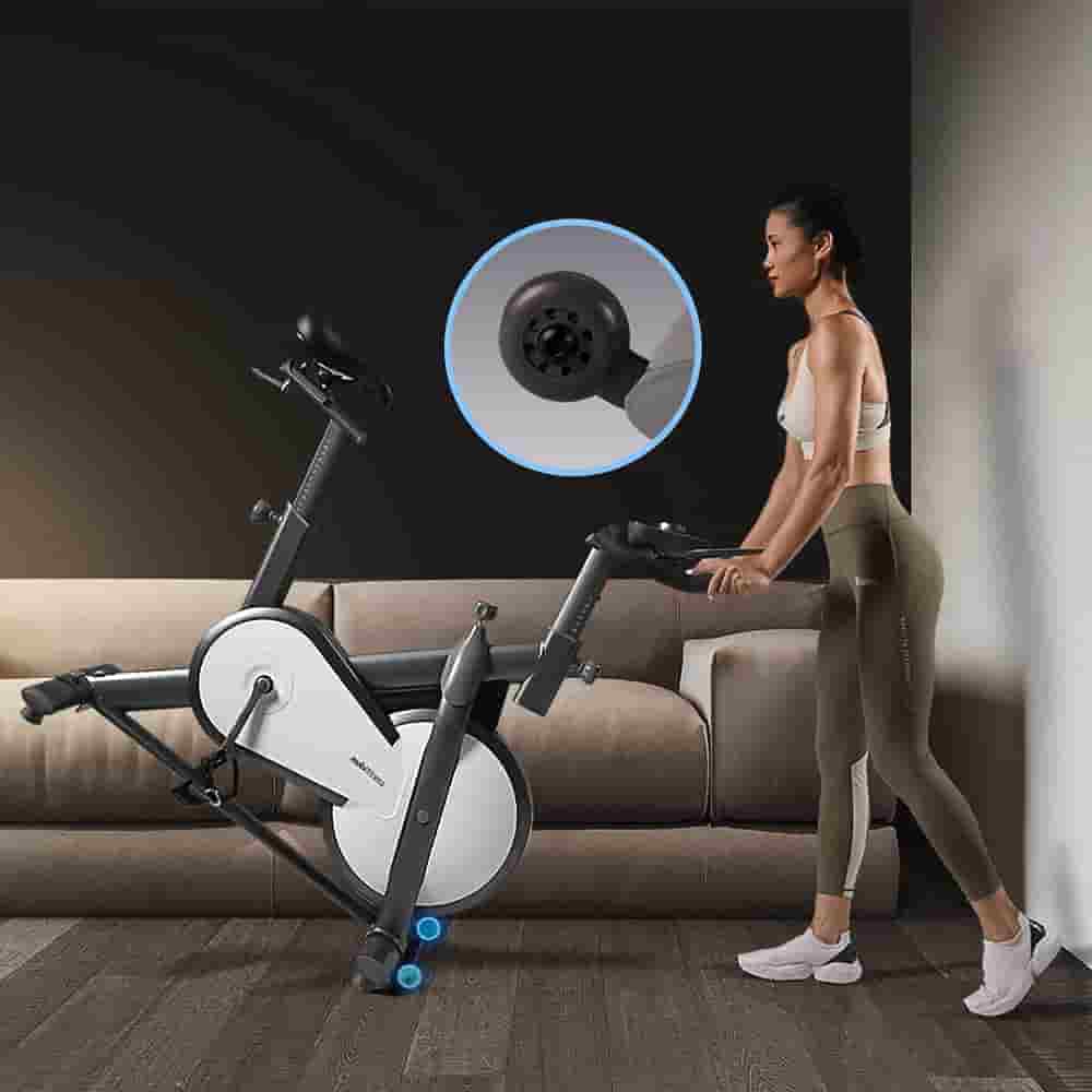User moves the Mobifitness TURBO Indoor Magnetic Exercise Bike tp storage area