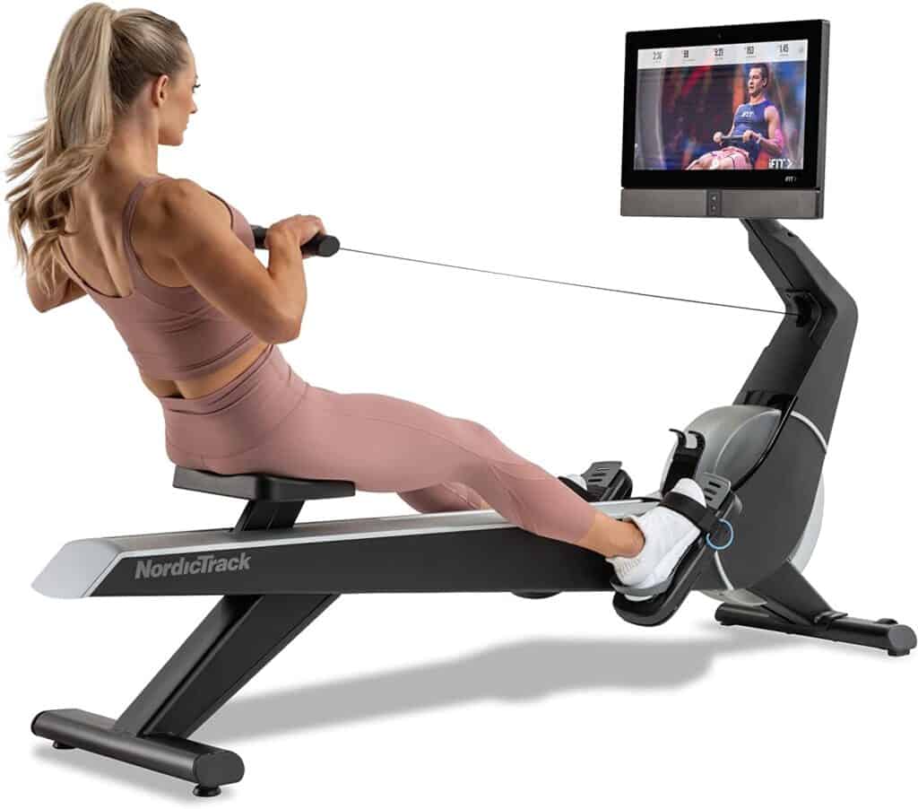 A lady exercises with the Nordic Track RW900 Rower