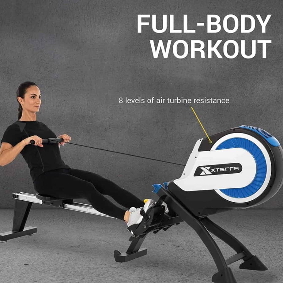 A lady exercises with the XTERRA Fitness ERG500 Air Turbine Rower